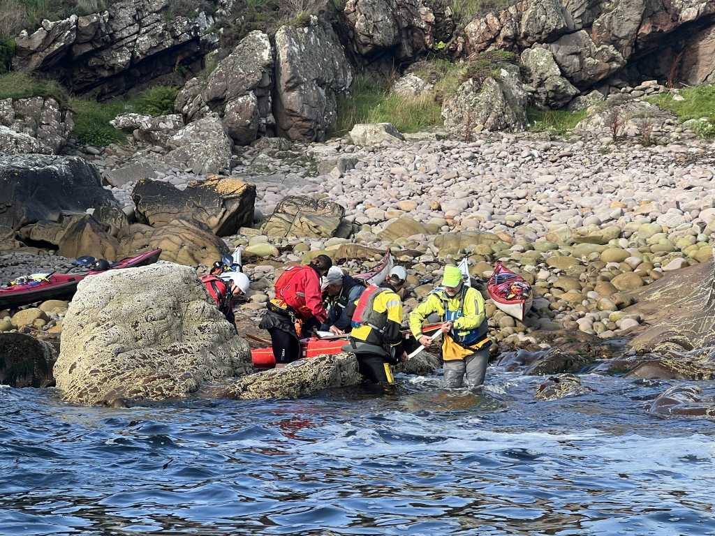 The group loading boats off the stony bay on Priest Island